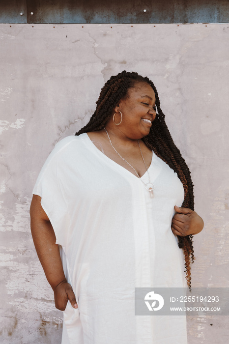 portrait of a plus size afro latinx haitian american woman wearing white looking away