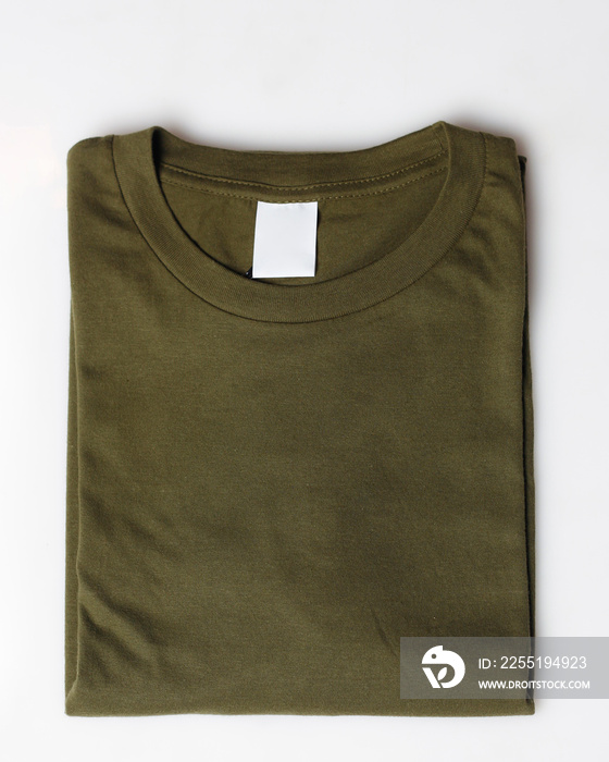 Dark green plain t-shirt mockup template. Plain t-shirt isolated on white background. Clothing for everyday. Perfect for your ad space. Space for your logo. Plain t-shirt for everyday wear. Focus blur