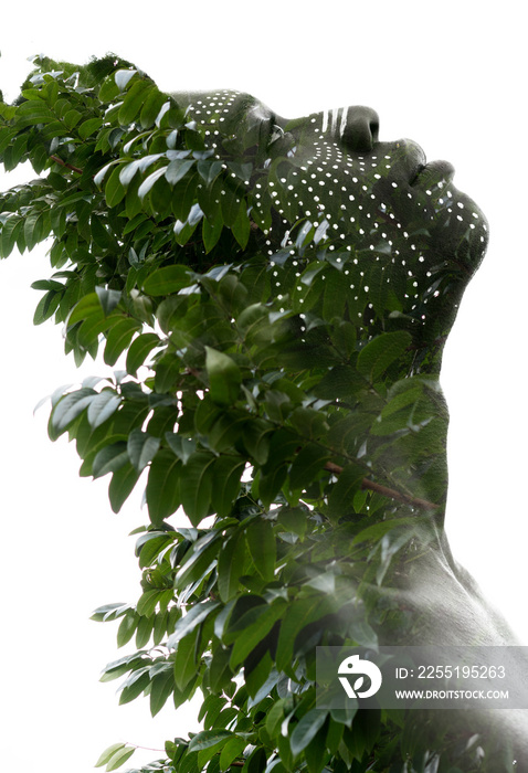 A double exposure portrait with tree leaves