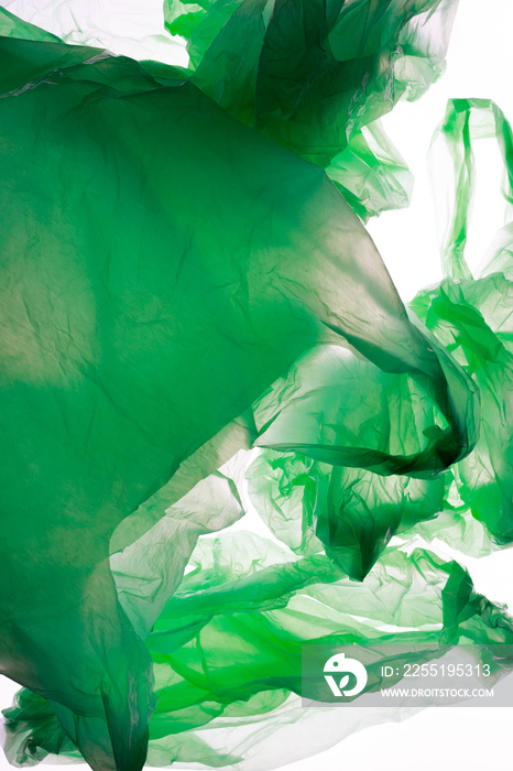 Crumpled green plastic bags isolated on white.