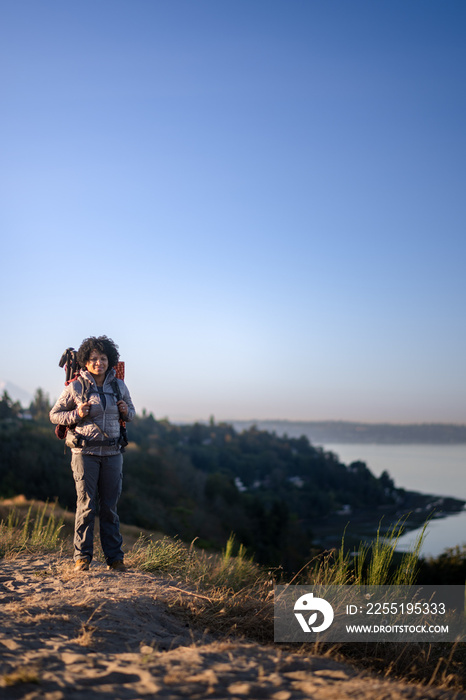 U.S. Army female soldier putting in the miles with an early morning hike in the NorthWest.