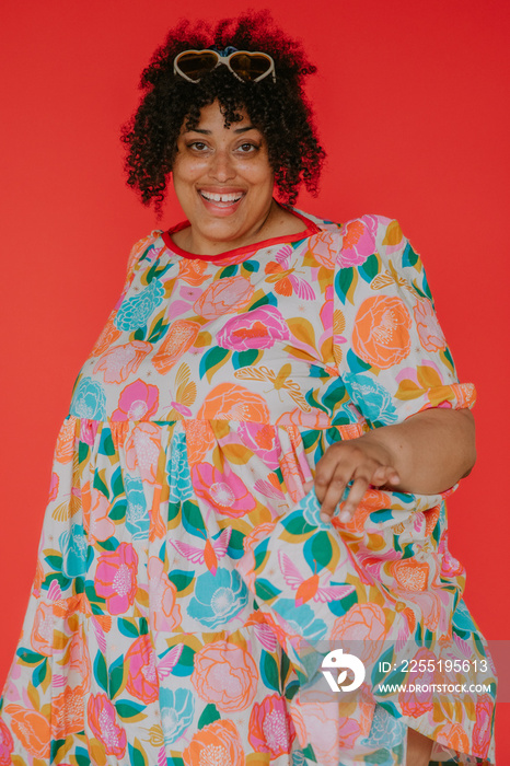 portrait of a person on a red backdrop