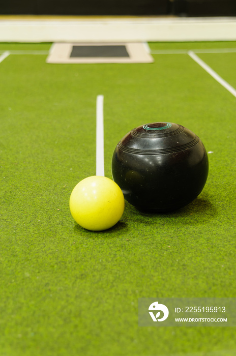 Bowl and jack on an indoor bowls carpet