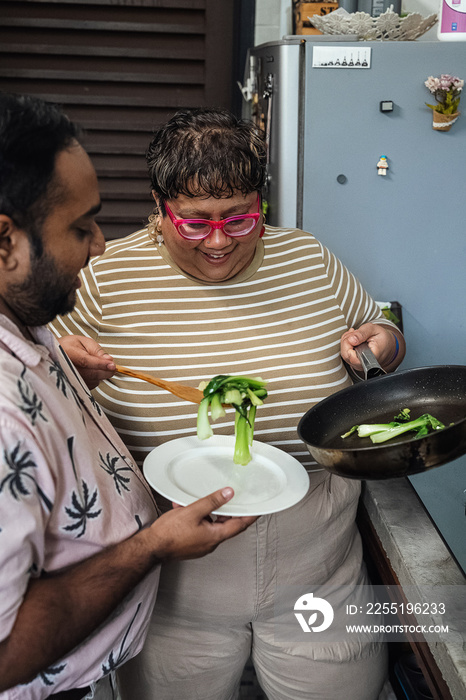 Plus sized parents making a healthy meal for the family