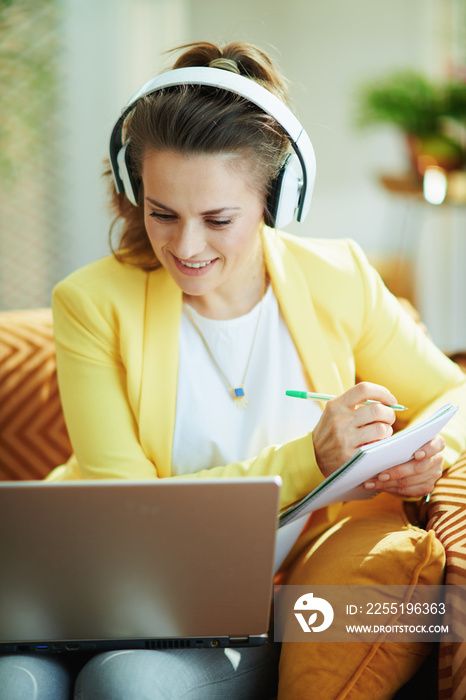 happy modern woman with headphones using video learning website