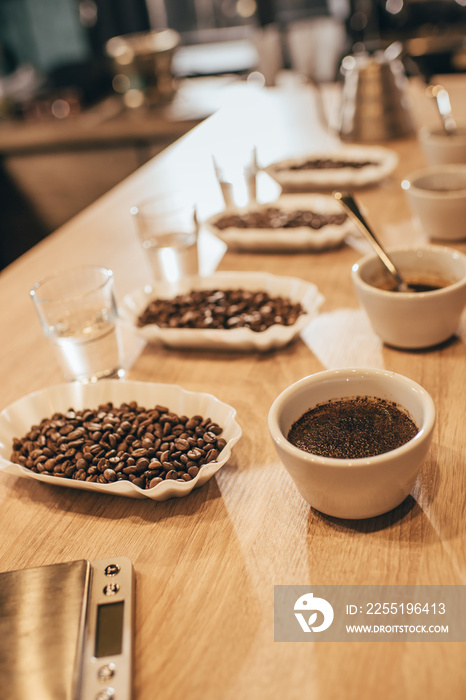 close up view of arranged bowls with coffee beans and grind coffee for food function on wooden tabletop