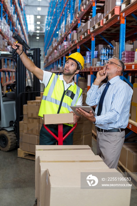 Businessman and warehouse worker