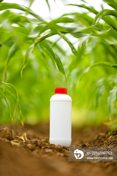 Protection of crops from pests and diseases. pesticide bottle at agriculture field.