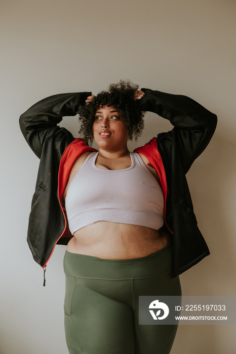 portrait of a plus size afro indigenous person stretching