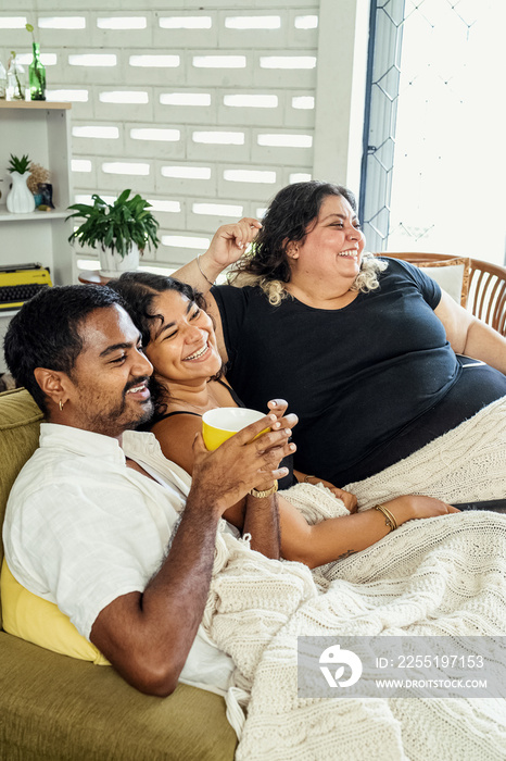 Friends watching tv together at home