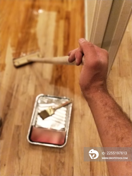 Hand extended polishing hardwood floors with polyurethane