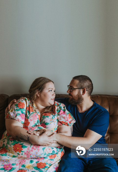 couple sitting on couch talking