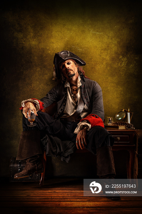 Portrait of a pirate drinking rum, sitting in a tavern