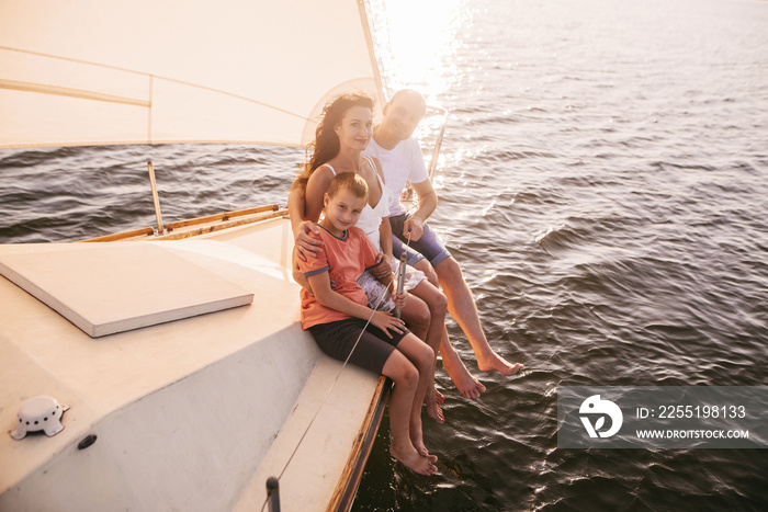 Happy family sailing on a luxury yacht or catamaran boat