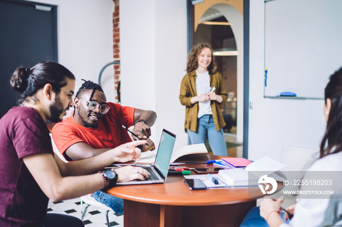 Modern students coworking on university project