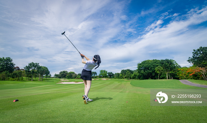 Professional woman golfer teeing  to hole  in player tournament competition at golf course for winner with green golf background.