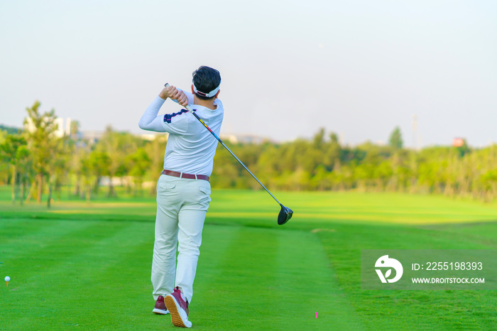 Man Golfer Hitting Ball with Club on Beatuiful Golf Course