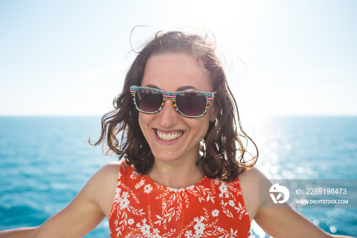 Portrait of a smiling woman on the background of the ocean