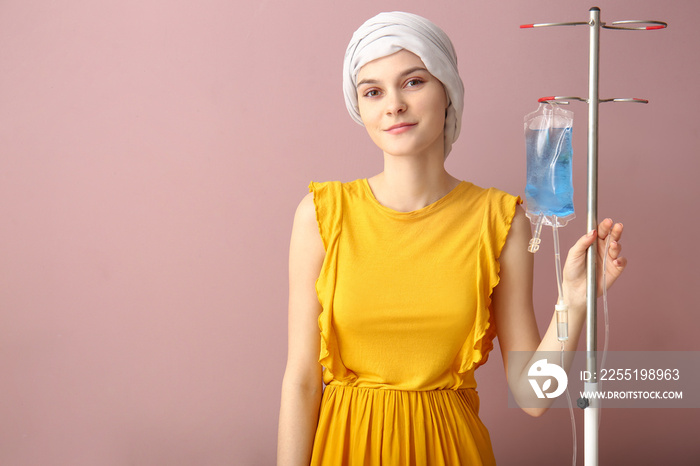 Young woman undergoing chemical therapy course against color background