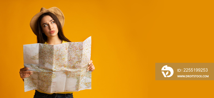 Girl Choosing Travel Destination With Tourist Map On Yellow Background