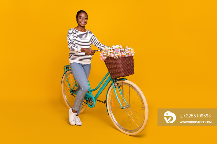 Full length profile side photo of young pretty lady enjoy free-time ride bicycle hobby event isolated over yellow color background