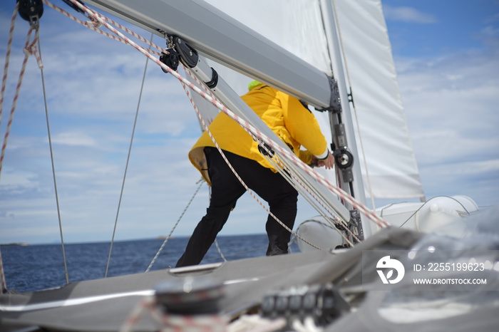 White bearded sailing senior, experienced skipper on a sailboat