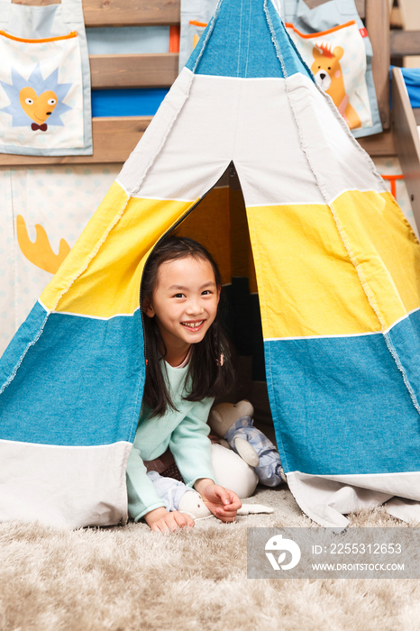 可爱的小女孩在帐篷里玩耍