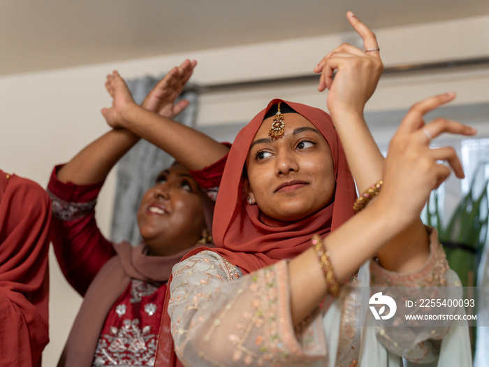 Women dancing during Ramadan celebration at home