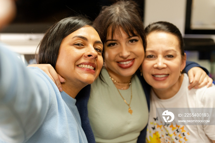 Portrait of three women embracing