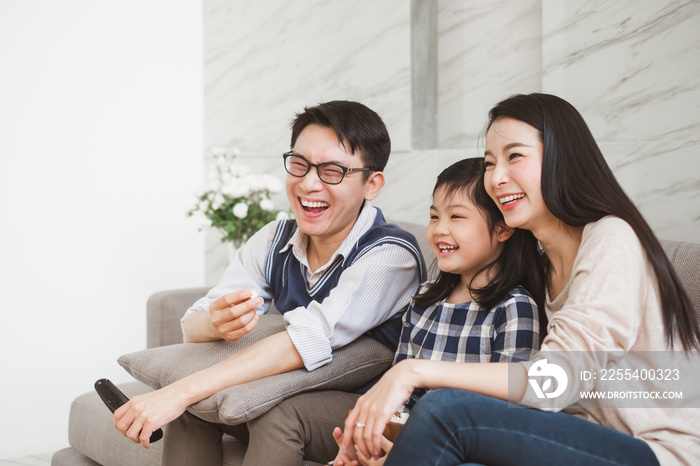 Happy Asian family lifestyle enjoy watching TV at home
