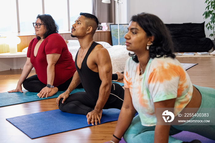 Group of friends meditating and doing yoga at home