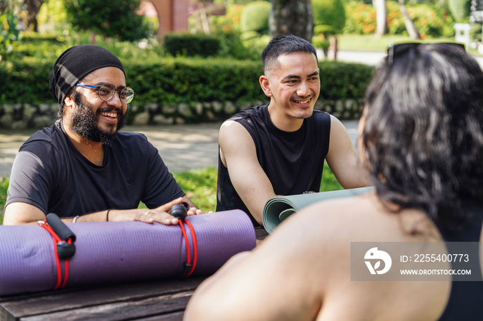 Groups of friends chatting together before doing yoga