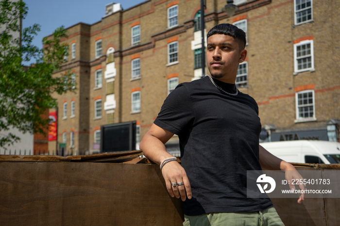 Young man wearing black tshirt looking away