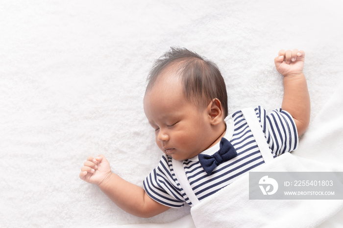 newborn asian boy baby sleeping on white furry