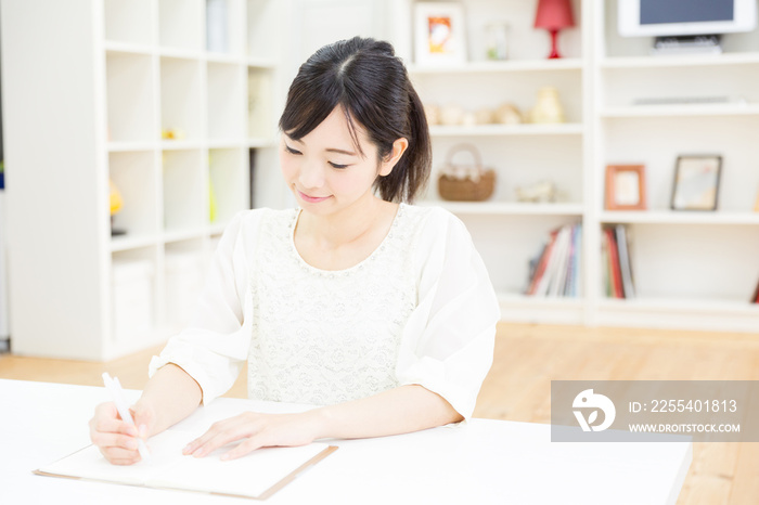 attractive asian woman writing