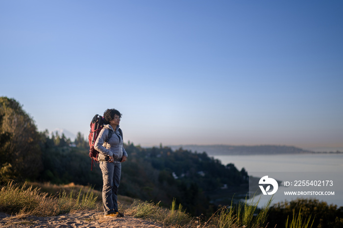 U.S. Army female soldier putting in the miles with an early morning hike in the NorthWest.