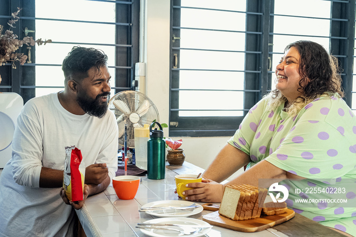 Couple making breakfast together at home in the morning