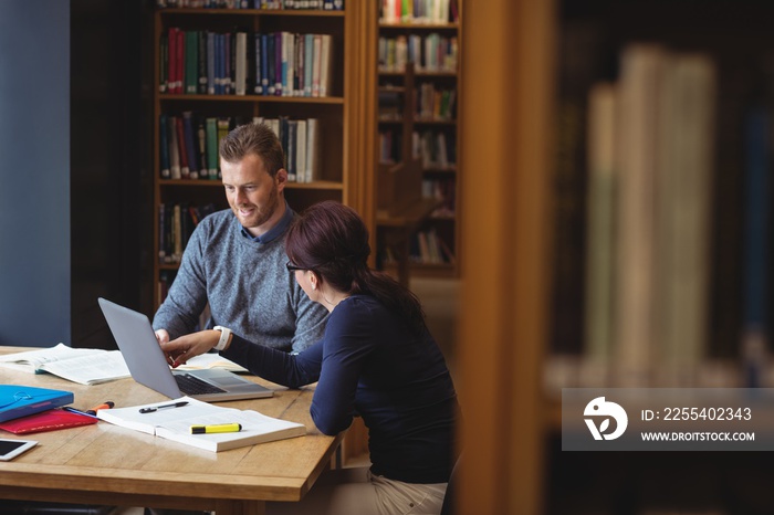 Mature students working together in college library