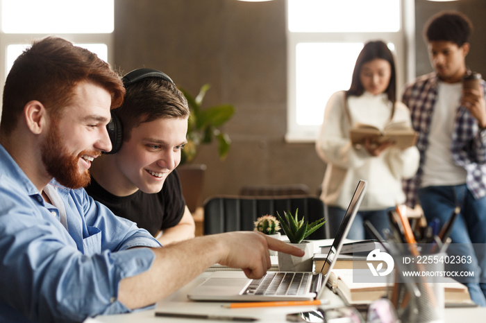 University students at library studying together and connecting online