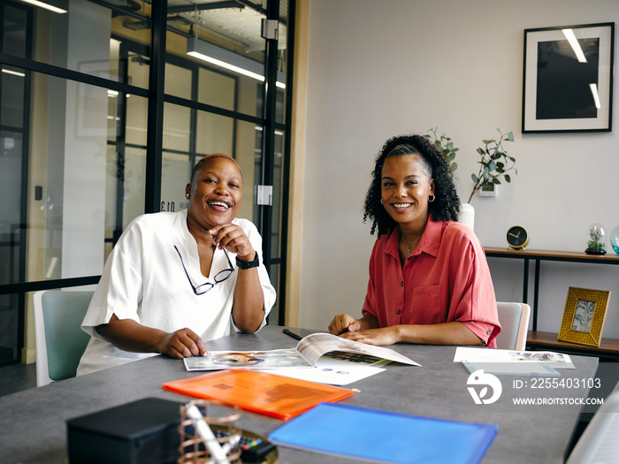 Two women sitting in office