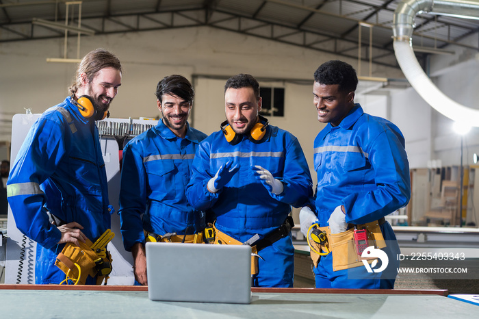 Team of male engineer workers working and meeting with laptop computer at warehouse