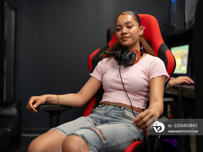 Portrait of young woman sitting on gaming chair