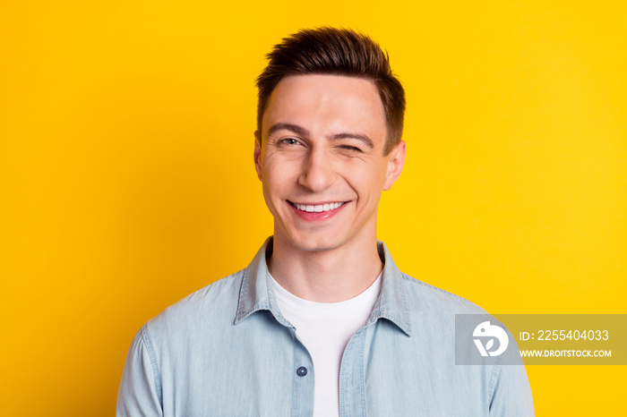 Portrait of young attractive handsome flirty man wink blink eye romance expression isolated on yellow color background