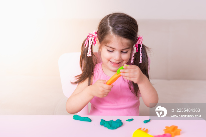 Portrait of Cute girl playing with toys for playdough