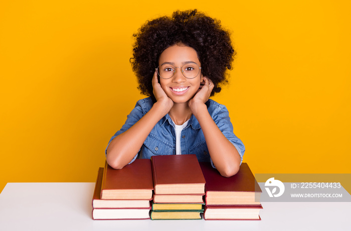 Portrait of beautiful trendy girl preparing academic project visiting public library isolated over bright yellow color background