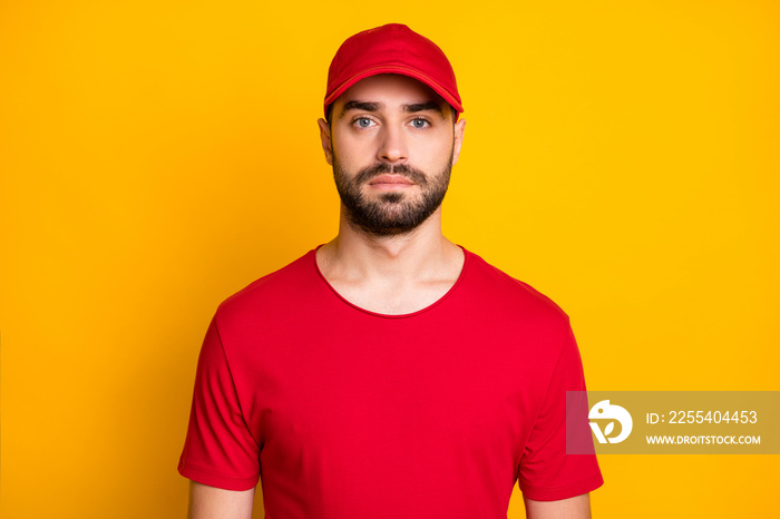 Close-up portrait of attractive content guy mailman wearing corporate uniform isolated over bright yellow color background