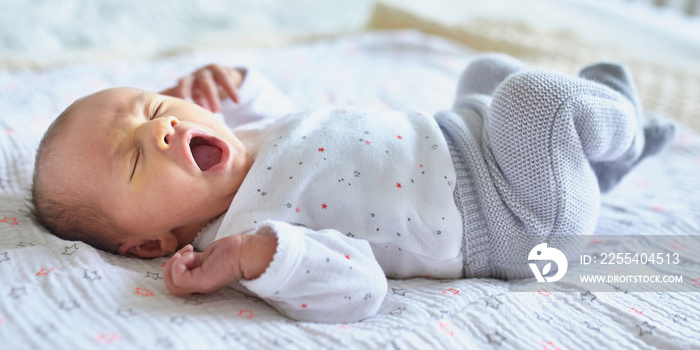 Newborn baby girl yawning