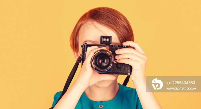 Child in studio with professional camera. Boy using a cameras. Baby boy with camera. Cheerful smiling child holding a cameras