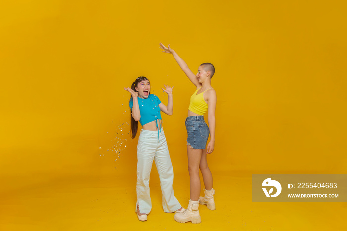 Studio portrait of smiling stylish friends with confetti