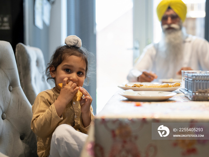 Portrait of boy in traditional clothing eating food